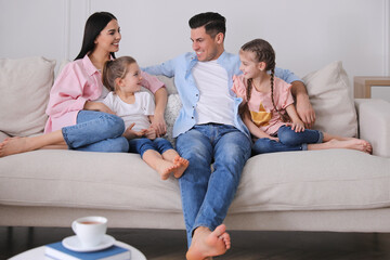Happy family resting on comfortable sofa in living room