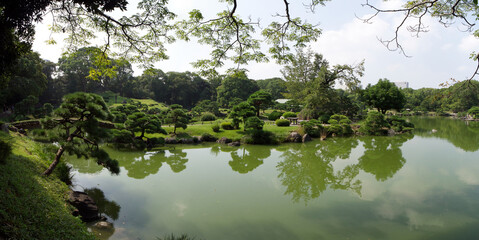Japanese Garden with reflection of trees in water green Kiyosumi 