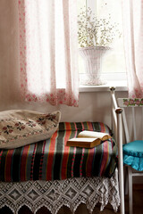 Vintage retro interior. old bed with traditional Krajina bedspreads. cute provence style.