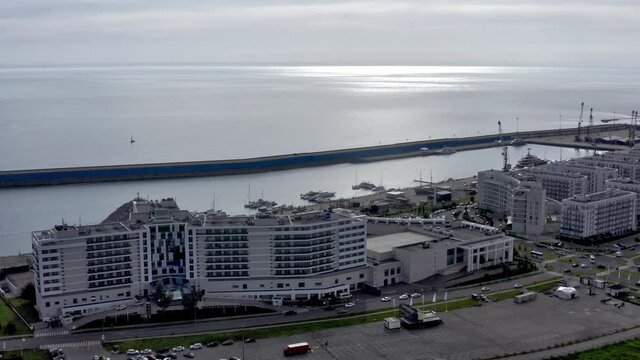 Aerial: Luxury boats and yahts standing near shore in grand marina