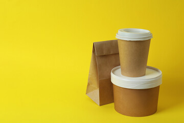 Delivery containers for takeaway food on yellow background