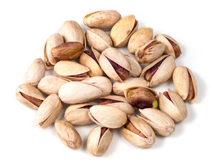 pile of ripe pistachio nuts closeup on white