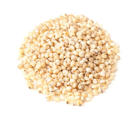 pile of raw Sorghum groats closeup on white