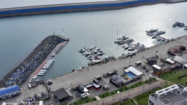 Aerial: Luxury boats and yahts standing near shore in grand marina