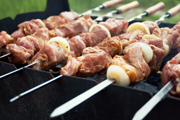 Marinated shashlik preparing on a barbecue grill over charcoal. Shashlik or Shish kebab popular in Eastern Europe. Shashlyk (skewered meat) was originally made of lamb. Roast Beef Kebabs On BBQ Grill.