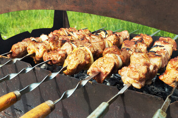 Marinated shashlik preparing on a barbecue grill over charcoal. Selective focus. Shashlyk (skewered meat) was originally made of lamb. Roast Beef Kebabs On BBQ Grill.