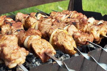Marinated shashlik preparing on a barbecue grill over charcoal. Selective focus. Shashlyk (skewered meat) was originally made of lamb. Roast Beef Kebabs On BBQ Grill..
