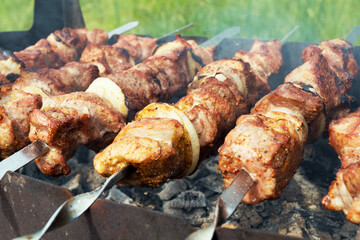 Marinated shashlik preparing on a barbecue grill over charcoal. Selective focus. Shashlyk (skewered meat) was originally made of lamb. Roast Beef Kebabs On BBQ Grill.