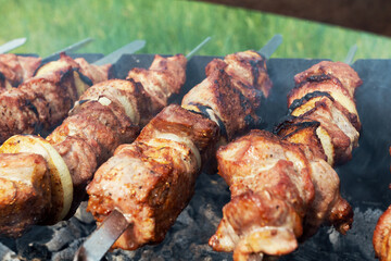 Marinated shashlik preparing on a barbecue grill over charcoal. Shashlik or Shish kebab popular in Eastern Europe. Shashlyk (skewered meat) was originally made of lamb. Roast Beef Kebabs On BBQ Grill.