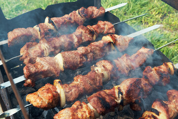 Marinated shashlik preparing on a barbecue grill over charcoal. Shashlik or Shish kebab popular in Eastern Europe. Shashlyk (skewered meat) was originally made of lamb. Roast Beef Kebabs On BBQ Grill.