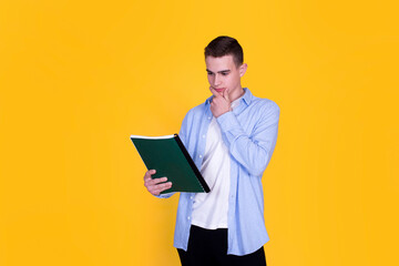 A handsome guy in a blue shirt  on a yellow background