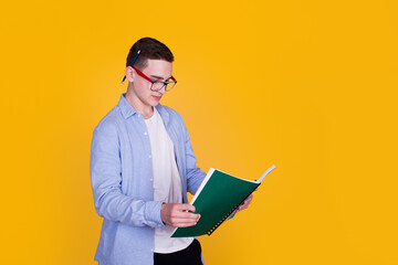 A handsome guy in a blue shirt  on a yellow background