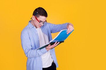 A handsome guy in a blue shirt  on a yellow background