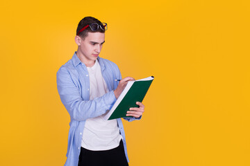 A handsome guy in a blue shirt  on a yellow background