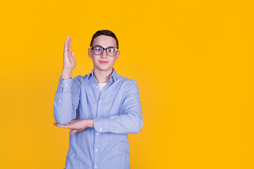 A handsome guy in a blue shirt  on a yellow background