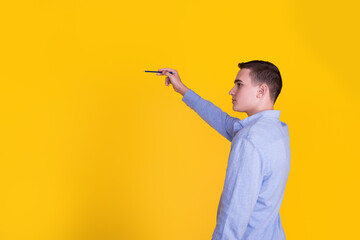 A handsome guy in a blue shirt on a yellow background