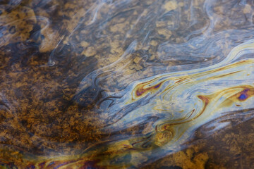 oil spills on puddle background, abstract gasoline nature pollution concept