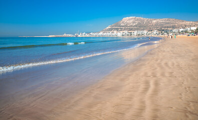Agadir beach on the Atlantic African coast in the summertime with yellow sand and turquoise water in Morocco - obrazy, fototapety, plakaty