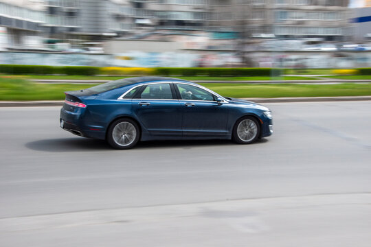 Ukraine, Kyiv - 26 April 2021: Blue Lincoln MKZ Car Moving On The Street. Editorial