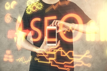 Multi exposure of man's hands holding and using a digital device and seo drawing. search...