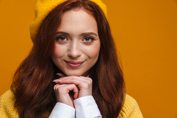 Happy young woman with long red hair in sweater