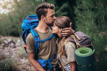 Fotobehang Young couple hiking together in mountains © Mediteraneo