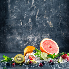 Fresh fruits background. Slices of fresh fruits on ice.