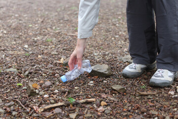 Hiker picking up trash in the mountain or park