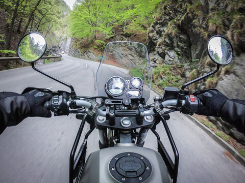 Riding motorcycle through a narrow mountain street fast © Photofex