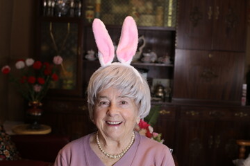 Fun senior woman with bunny ears 