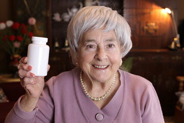 Senior woman holding pills bottle