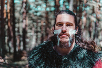 Viking with war paintings in a Norwegian forest
