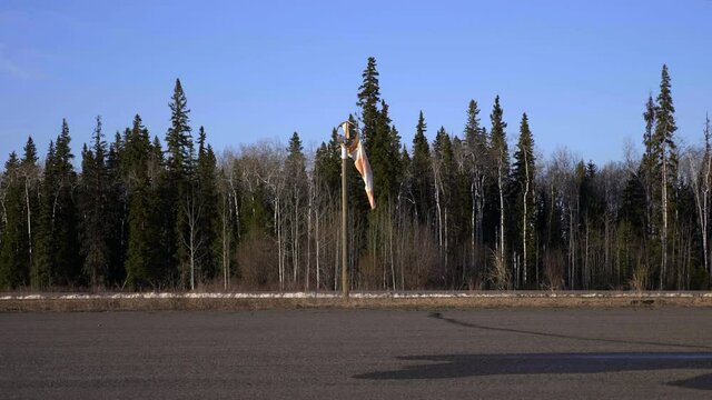 A Broken Windbag On Runway Of Fort St. James, British Columbia, Canada During Sunny Day. - Static Shot