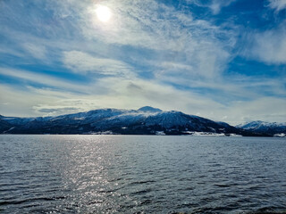 lake and mountains covered with snow and ice