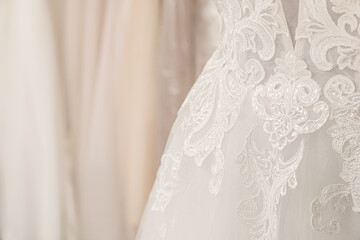 Fototapeta na wymiar Beautiful wedding dress on mannequin in boutique, closeup