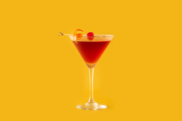 Traditional Manhattan cocktail with cherry on yellow background