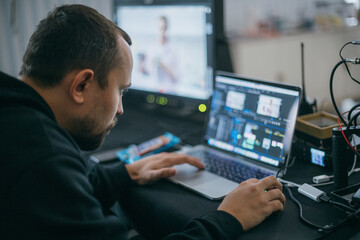 Editing director behind monitors on the set.