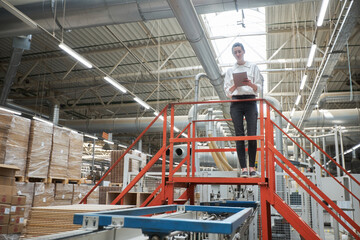 Business woman portrait in the carpentry factory using tablet pc. Carpentry factory. Factory for the production of parquet board