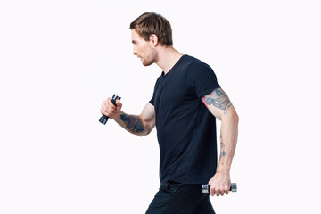 sporty man with dumbbells on white background her tattoo on arm black t-shirt cropped view