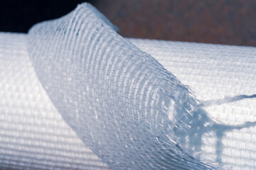 Lapel part of a roll of fiberglass wallpaper close-up. Selective focus.