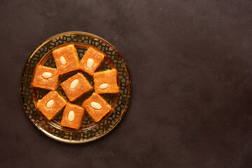 Middle eastern semolina sweets basbousa , namoora, hareesa  . Top view with copy space