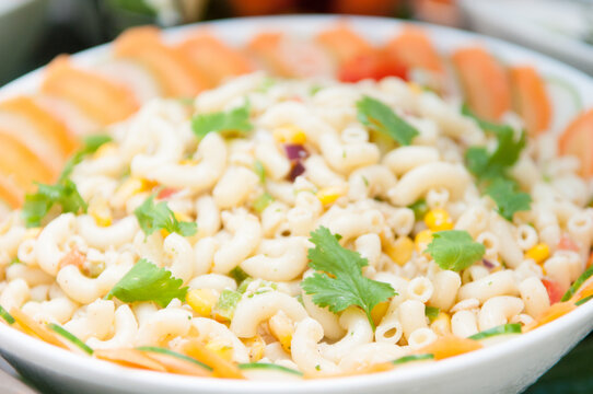 Closeup Shot Of Macaroni Salad With Vegetables In A White Bowl