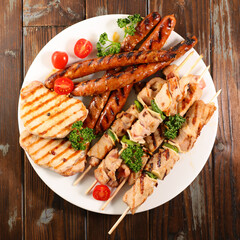 grilled barbecue meats- sausage, pork chop and skewer