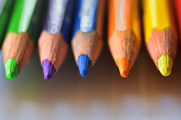 Top down view of neatly arranged tips of colored pencils.