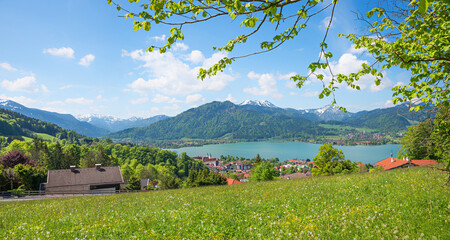 view to lake Tegernsee and spa town, alpine spring landscape with green trees, upper bavaria