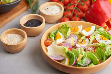 Diet menu. Healthy salad of fresh vegetables - tomatoes, egg, Onion. high angle view of a nutritious vegetable salad with boiled egg slices, served.  Healthy meal concept.