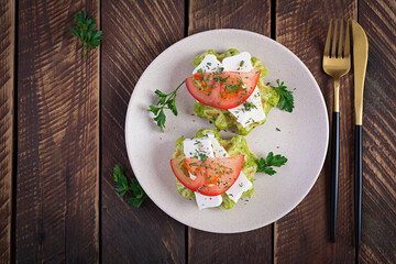 Delicious homemade spinach vegetarian  waffles with feta cheese and tomatoes. Top view, flat lay