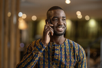 Traditional black African business entrepreneur, using smart phone