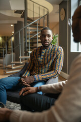 Candid meeting, two black african businessmen, traditional clothing