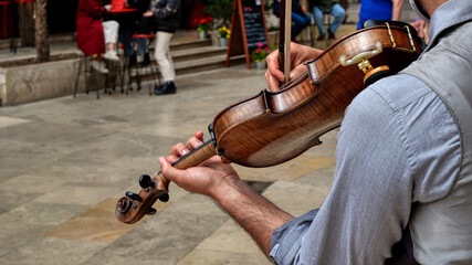 Violin close-up. On a sunny day, a musician plays on the street of Valencia